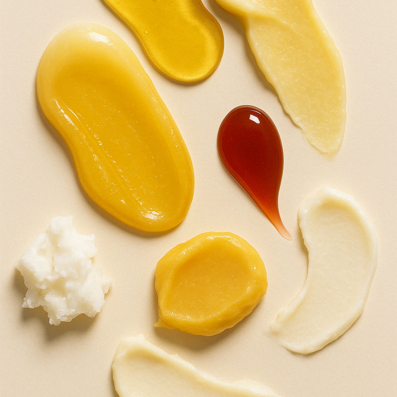 Various types of creams and ingredients on a beige background